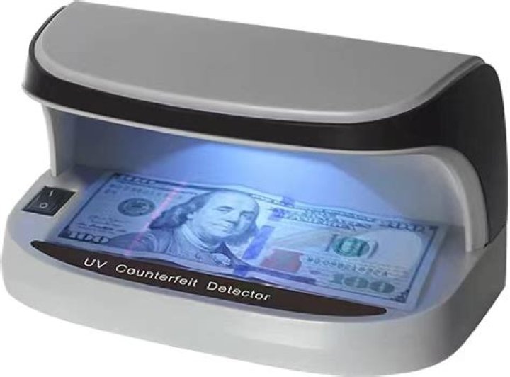 How can a UV light detect counterfeit bills?