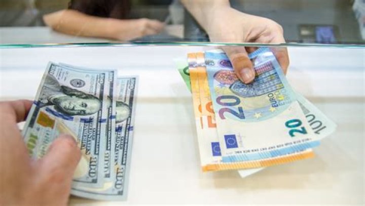 Where is the best place to exchange your money before traveling to another country with a different currency?